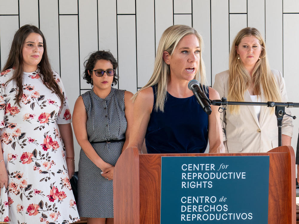 Amanda Zurawski speaks during a press conference outside the Travis County Courthouse on July 19, 2023. Ashley Brandt, Elizabeth Weller and Lauren Miller stand behind her.
