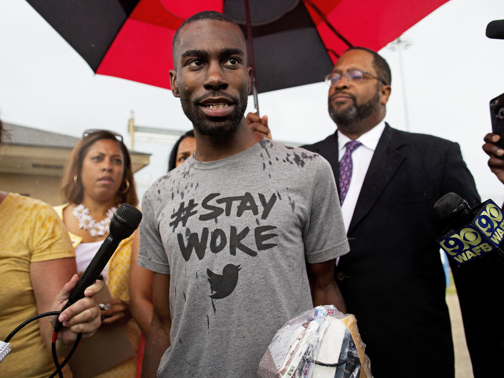 In this July 10, 2016, file photo, Black Lives Matter activist DeRay Mckesson talks to the media after his release from jail in Baton Rouge, La., wearing a 