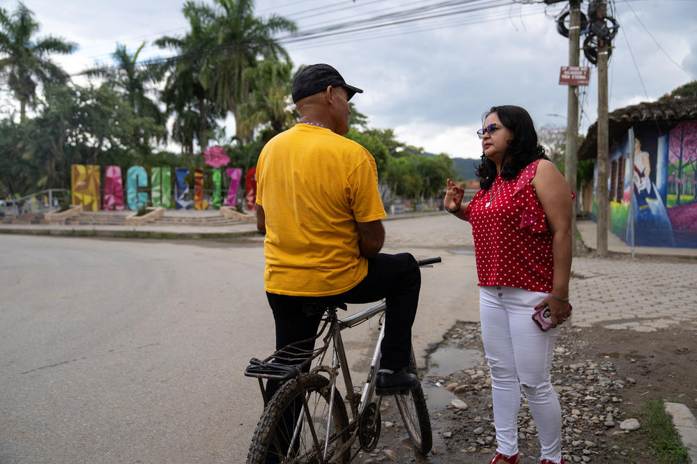Mayor Jacqueline Trejo greets one of her constituents. She's seen the town population dwindle as residents leave to seek a better life in the U.S. Her challenge: How to raise money to improve life for those who've stayed in Macuelizo.