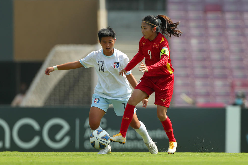 Huynh Nhu of Vietnam, in red, controls the ball during a Women's Asian Cup play-off game in February.