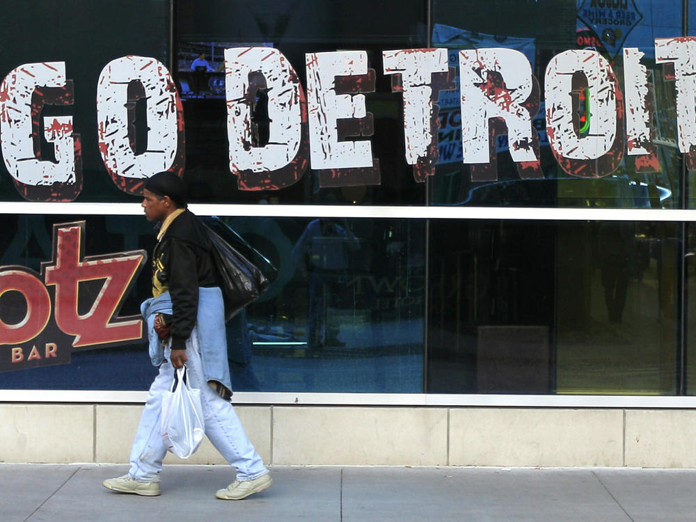 In this Oct. 24, 2012 file photo, a pedestrian walks in Greektown in downtown Detroit. A state-appointed review team Tuesday, Feb. 19, 2013 determined Detroit is in a financial emergency, paving the way for Republican Gov. Rick Snyder to appoint an emergency manager who would need to come up with a new plan to get the city out of its fiscal crisis.