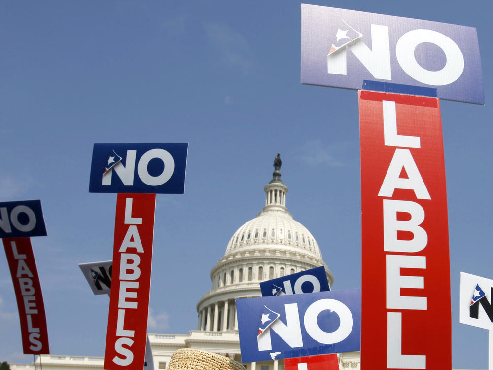 People with the group No Labels hold signs during a rally on Capitol Hill in Washington, D.C., on July 18, 2011.