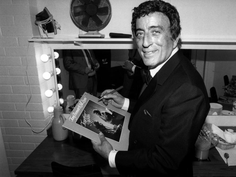 Tony Bennett poses while signing an autograph in 1988.