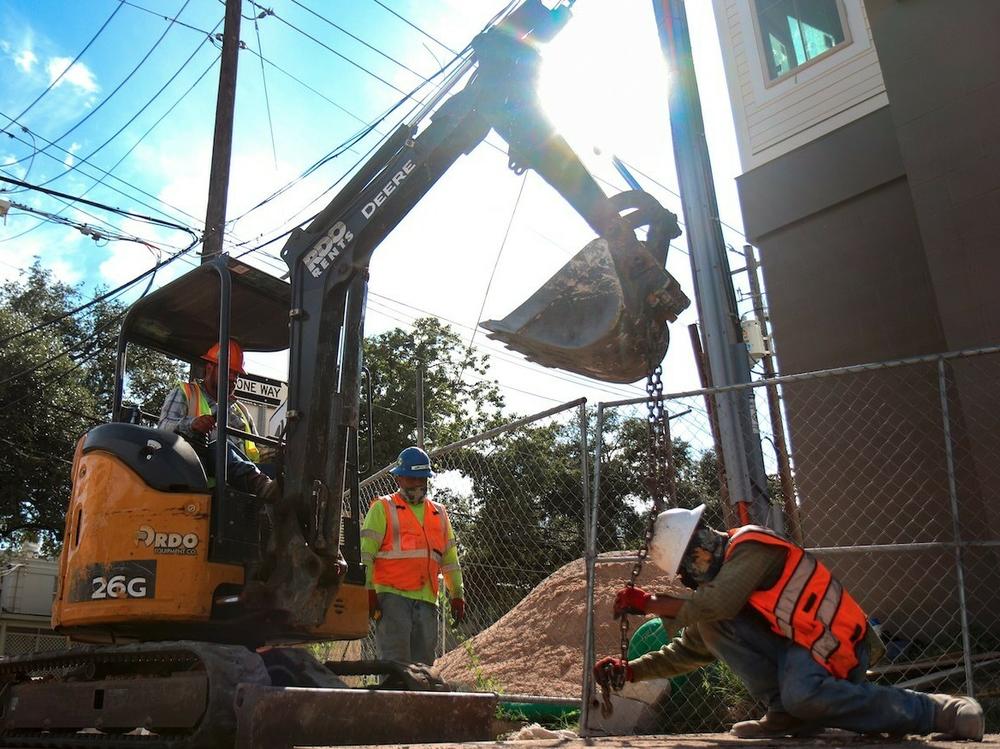 Austin, Texas, construction workers dig on a hot day in August 2021. Last month, Gov. Greg Abbott signed a bill that overturns local ordinances in some Texas cities that mandate regular rest breaks for such workers.