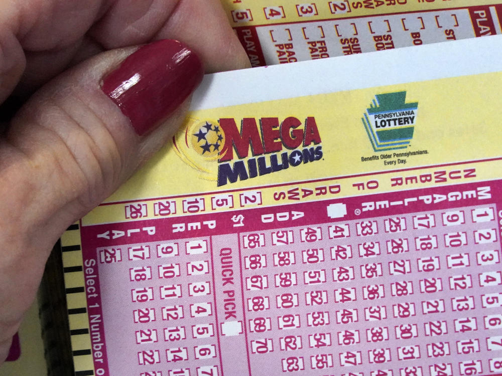 A Mega Millions wagering slip is held in Cranberry Township, Pa., on Jan. 12, 2023.