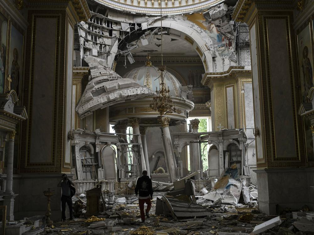 Church personnel inspect the damage inside the Transfiguration Cathedral in Odesa, Ukraine, Sunday, following Russian missile attacks.