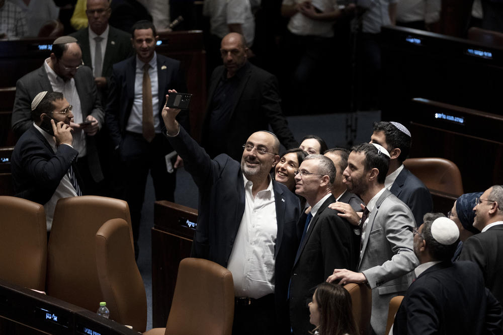 Israeli lawmakers celebrate by taking a selfie with Justice Minister Yariv Levin, center right in the foreground, after approving a key portion of Prime Minister Benjamin Netanyahu's divisive plan to reshape the country's justice system, on the floor of the Knesset, Israel's parliament, in Jerusalem on Monday.