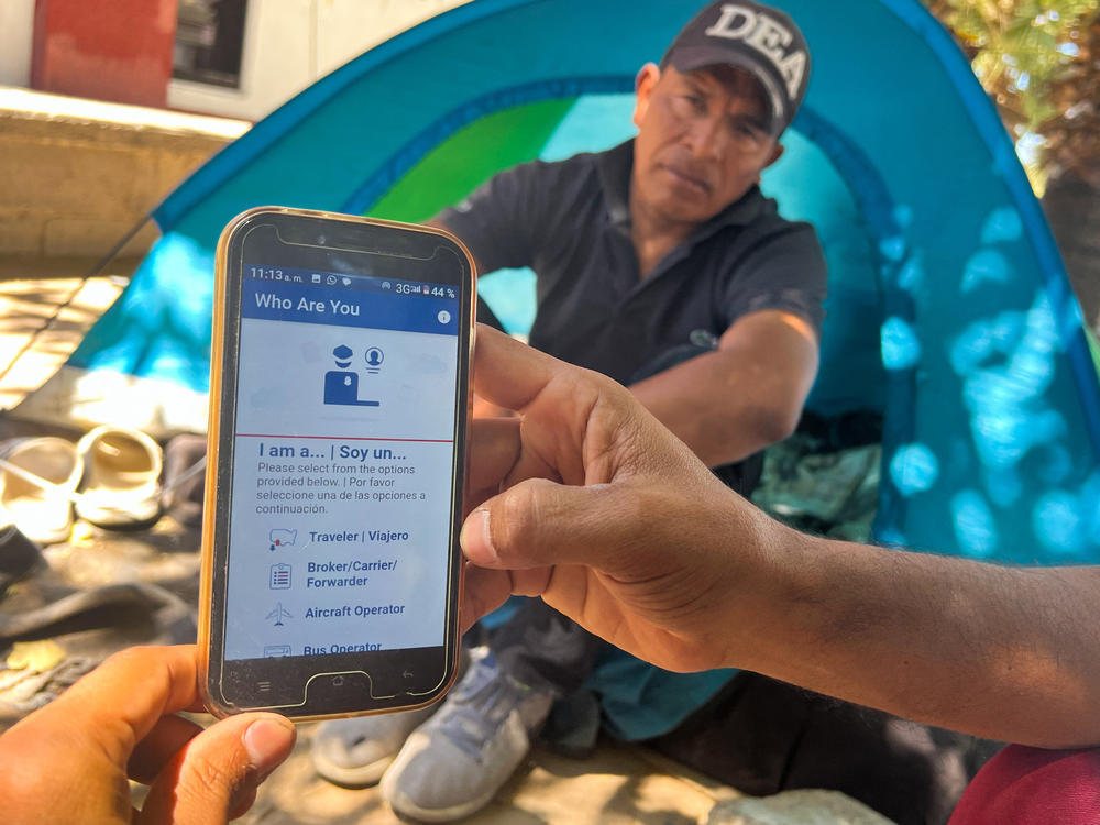 A migrant in Ciudad Juárez, Mexico, displays the CBP One app used to apply for an appointment to claim asylum in the U.S.