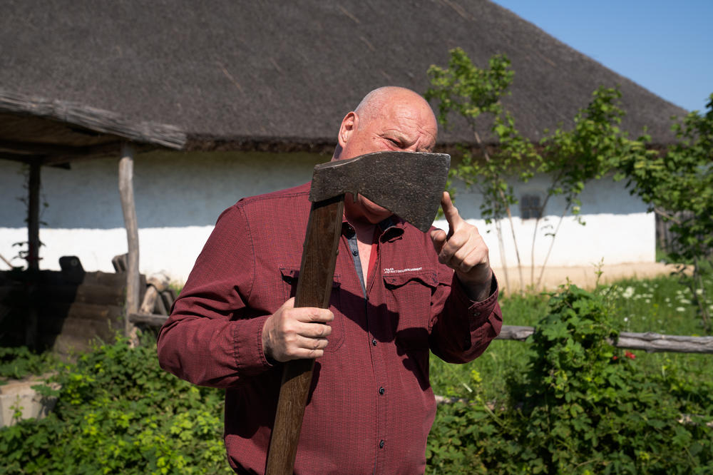 Kopishinskyi tests the blade of an ax that was in the museum at the sich.