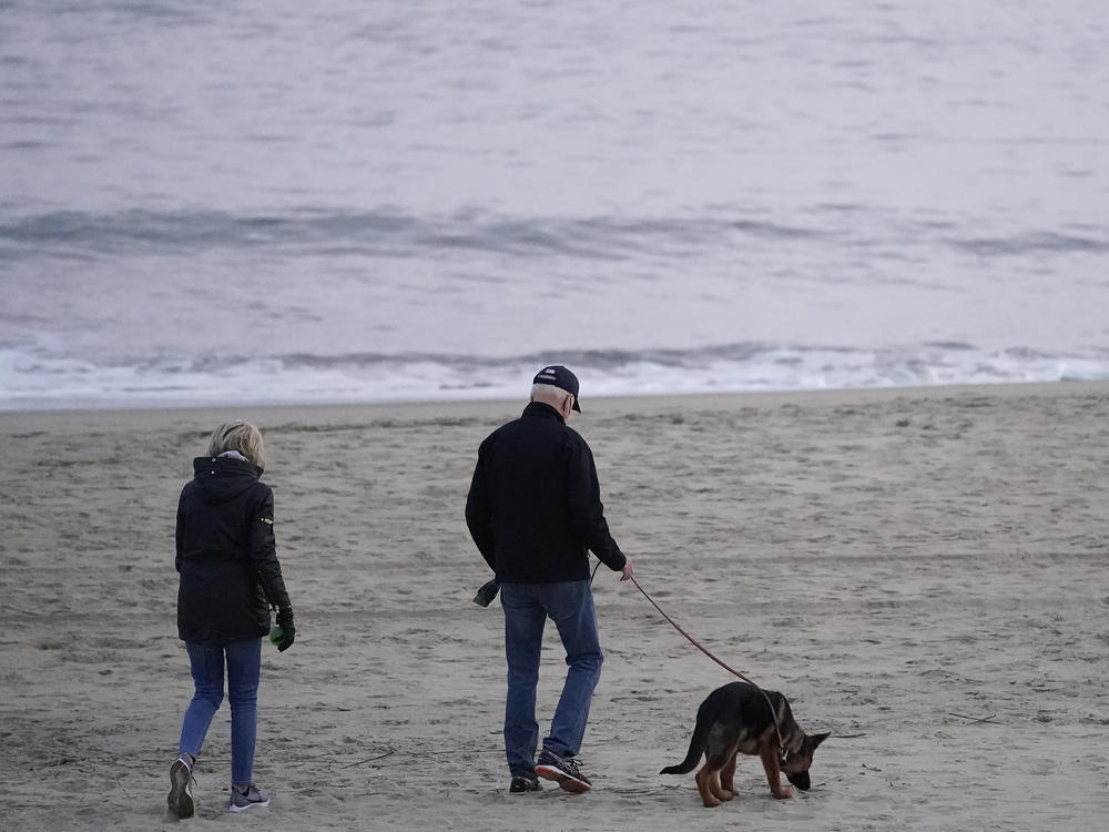 The Bidens take Commander for a walk in Rehoboth Beach, Del., on Dec. 28, 2021.