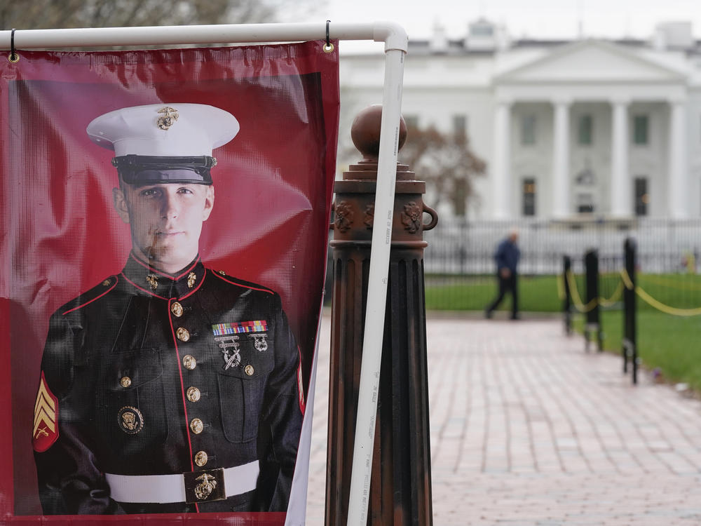 A poster photo of U.S. Marine Corps veteran and former Russian prisoner Trevor Reed stands in Lafayette Park near the White House, March 30, 2022, in Washington. Reed, a former U.S. Marine who was released from Russia in a prisoner swap last year, has been injured while fighting in Ukraine, the State Department said.