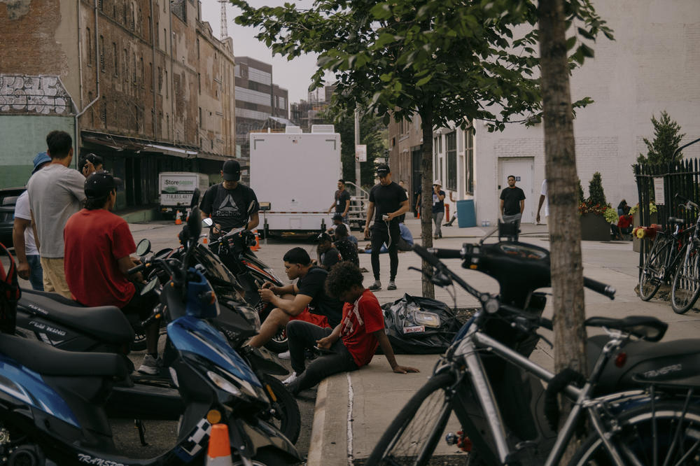 Unable to legally employment, some residents work as delivery drivers in, Brooklyn, New York, U.S., on Wednesday, July 19, 2023.
