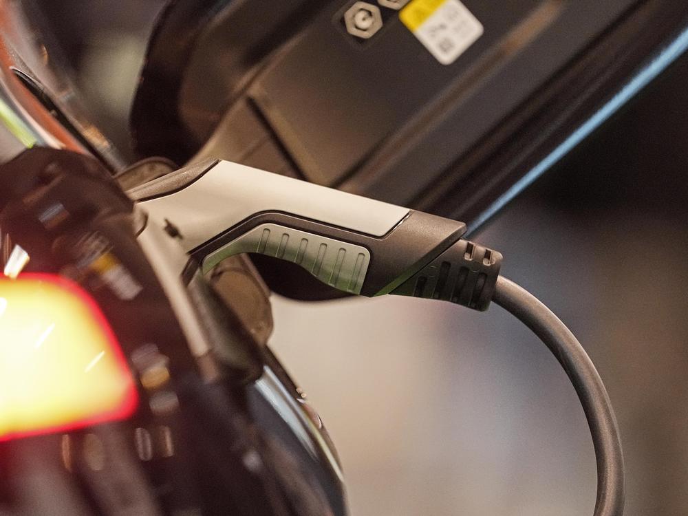An electric car is charged at the Motor Show in Essen, Germany, Thursday, Dec. 2, 2021. Charging may soon be easier across the U.S. with seven car companies banding together to create a charging network.