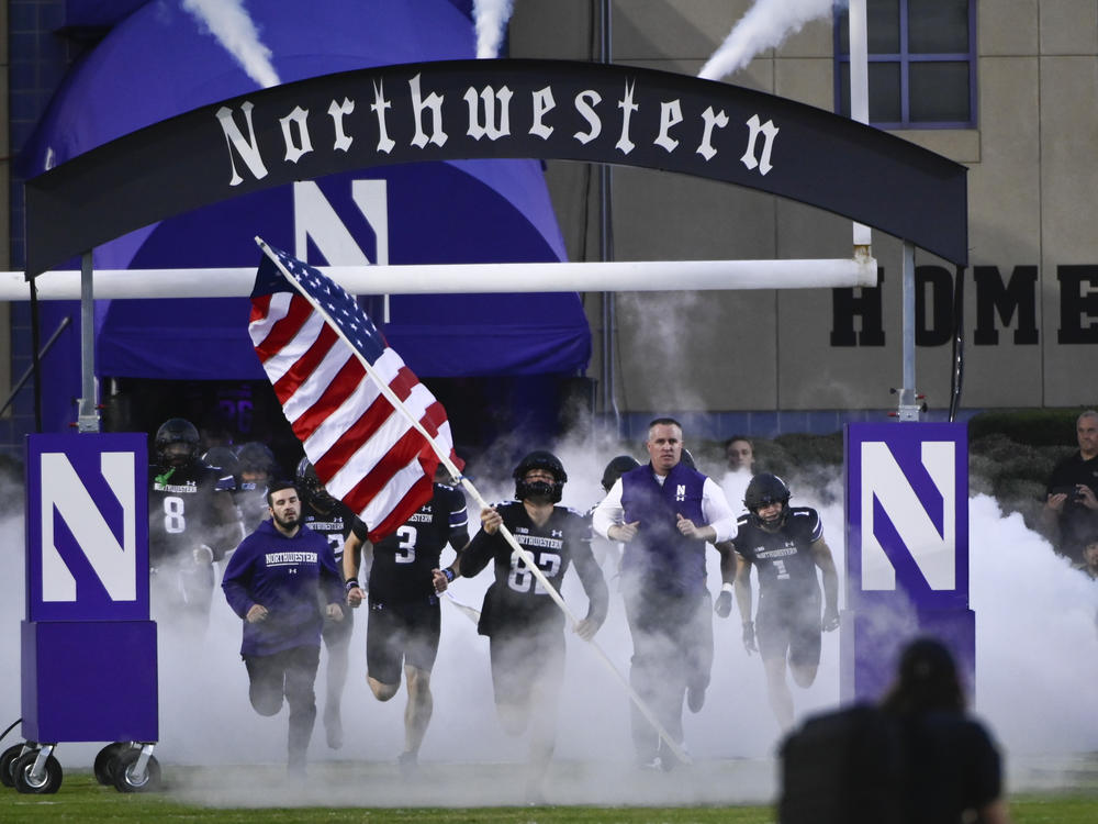 At Northwestern University, allegations of hazing in its football program led to the firing of longtime coach Pat Fitzgerald (right) and has the school facing multiple lawsuits, with more likely. Here, Fitzgerald leads the football team onto the field on Sept. 24, 2022, in Evanston, Illinois.