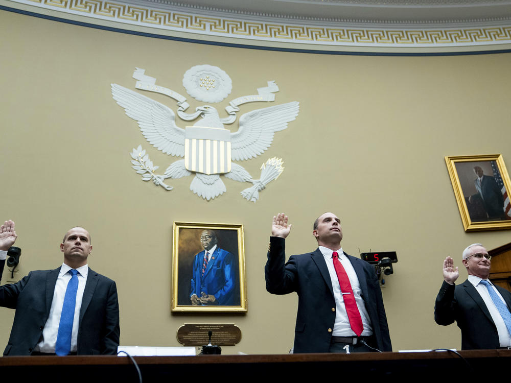 Ryan Graves, executive director of Americans for Safe Aerospace (left), retired Air Force Maj. David Grusch and retired Navy Cmdr. David Fravor are sworn in during a House Oversight and Accountability subcommittee hearing on UFOs on Wednesday.