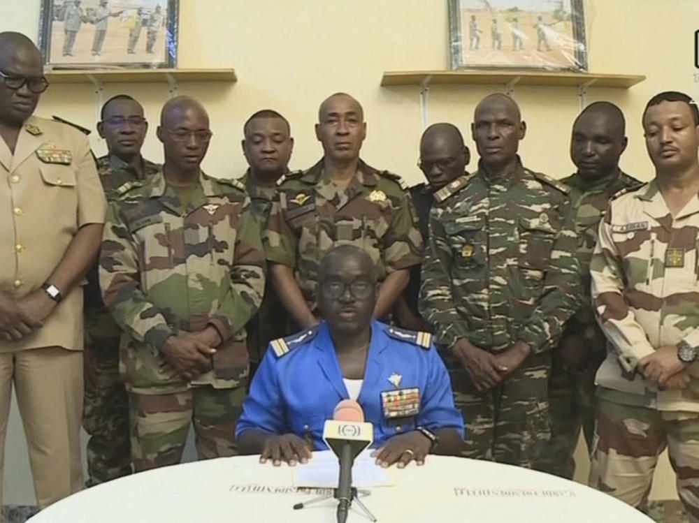 Col. Major Amadou Abdramane, center, is shown speaking during a televised statement. Soldiers claimed on July 26, 2023, to have overthrown the government of Niger President Mohamed Bazoum in a statement read out on national television.