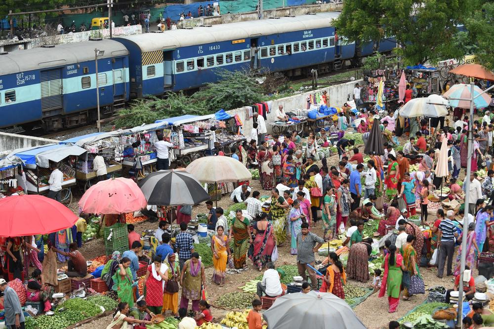 Customers shop at a fruit and vegetable market in Ahmedabad, India, in 2017.