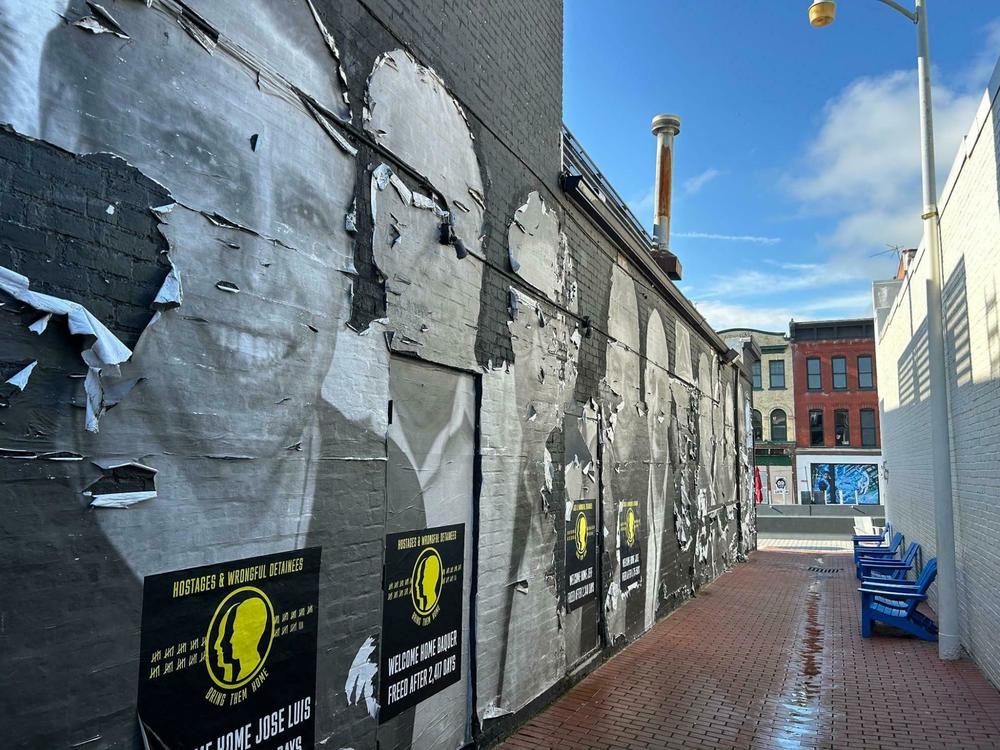 <em>Artist Isaac Campbell made this mural in Washington, D.C. one year ago using materials that were meant to decay. It depicts  Americans detained abroad.</em>