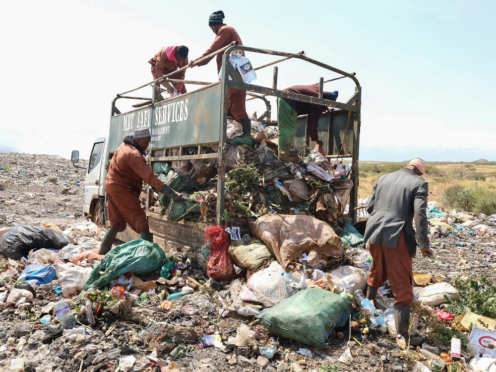 Trash collectors from Marsabit Safi Services offload waste at the Dadach Boshe dump. Even though Kenyan banned single-use plastic bags in 2016, they're still piling up at the dump and blowing off to litter the landscape and bodies of water.