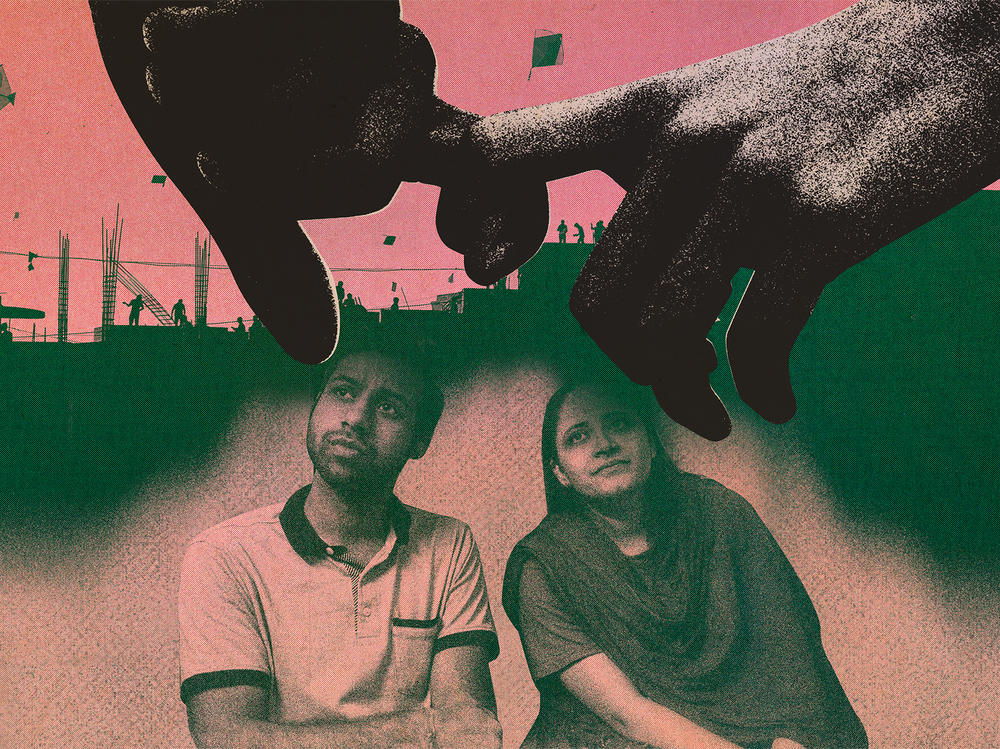 Saumil and Zarina sit on the floor at the Love Commandos shelter in New Delhi.