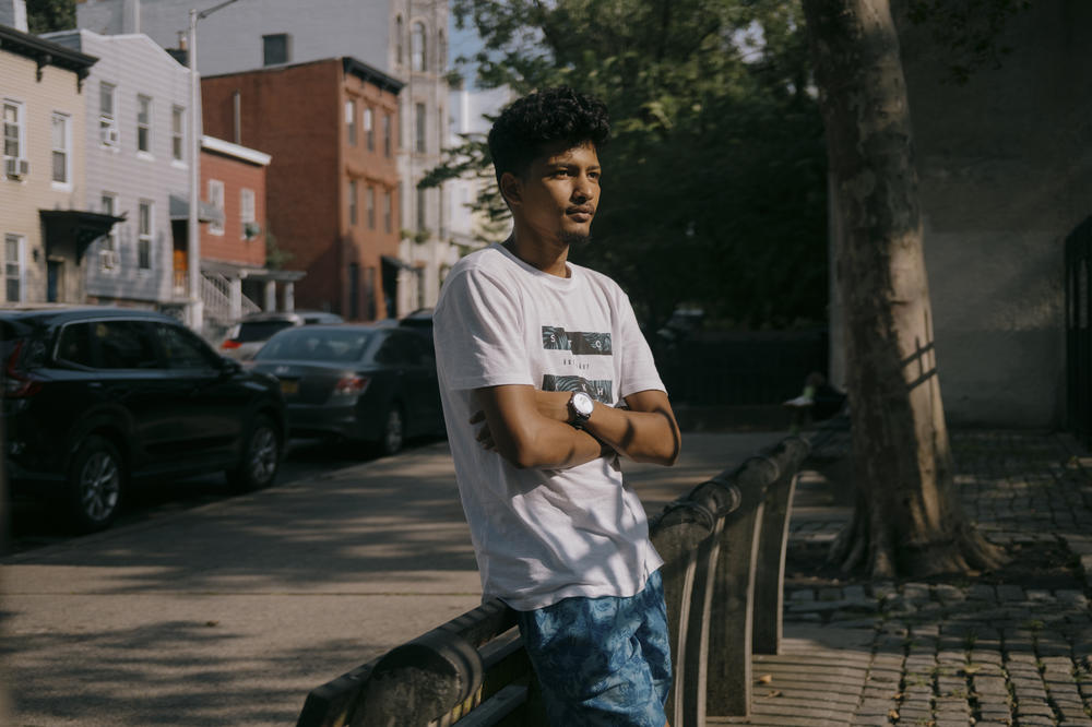 Elcoutoub, 21, an asylum seeker from Mauritania, has has spent 20 days at the Clinton Hall shelter. He stands outside of Washington Hall Park as he seeks relief from the congested confinements of 47 Hall Street in Brooklyn, New York, U.S., on Wednesday, July 19, 2023.