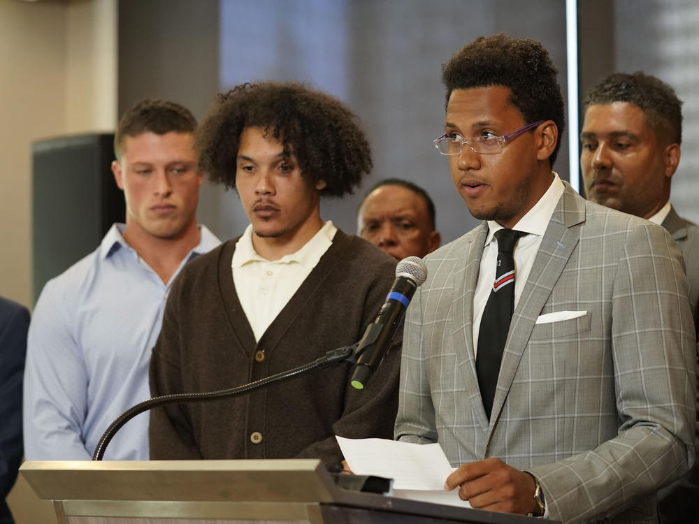 Standing with other former Northwestern athletes, former Northwestern football player Lloyd Yates (right) speaks during a news conference addressing widespread hazing accusations at Northwestern University, on July 19 in Chicago.