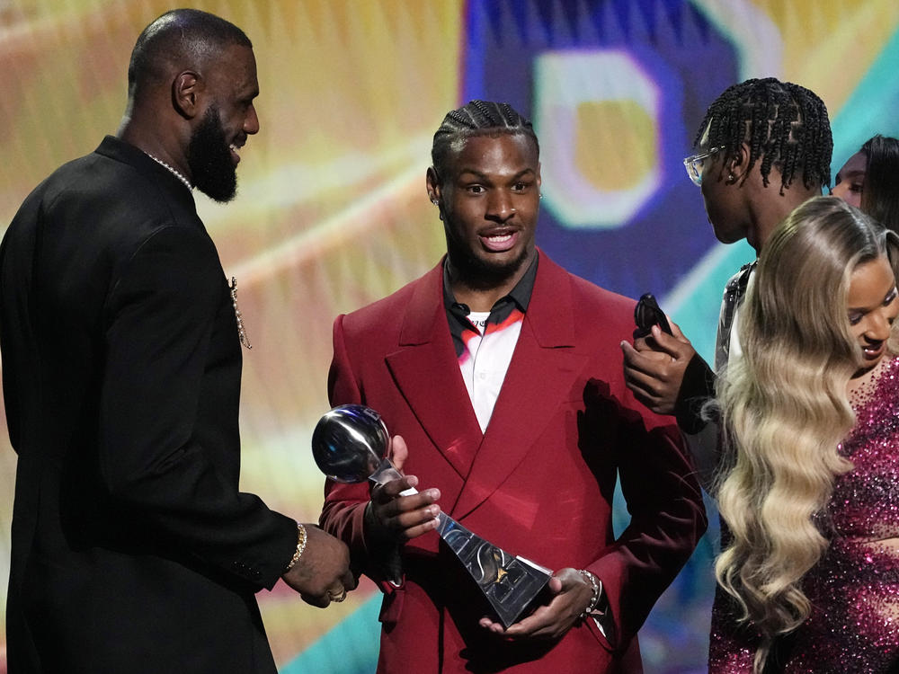 Los Angeles Lakers' LeBron James, left, accepts the award for best record-breaking performance from his sons, Bronny James, center, and Bryce James, at the ESPY awards July 12, 2023, in Los Angeles. Bronny James was hospitalized in stable condition Tuesday, July 25, 2023, a day after going into cardiac arrest while participating in a practice at the University of Southern California.