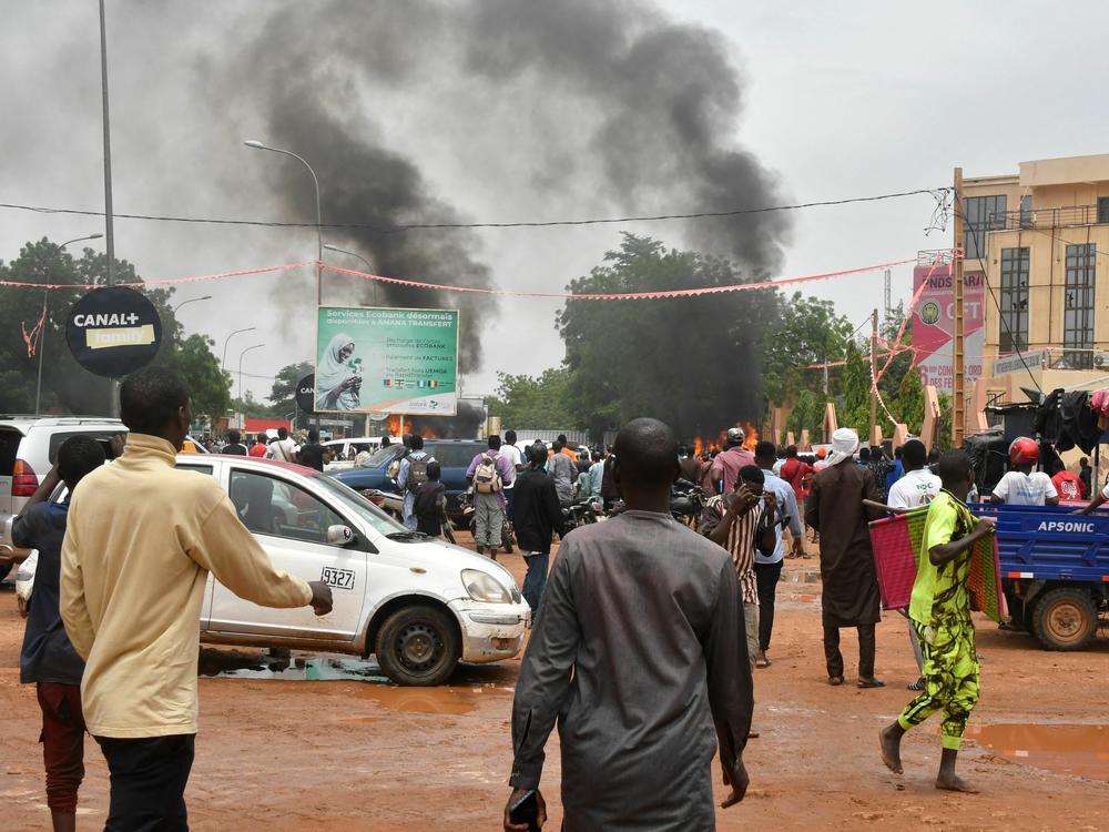 A general view of billowing smoke as supporters of Niger's defense and security forces attack the headquarters of the Nigerien Party for Democracy and Socialism, the party of overthrown President Mohamed Bazoum, in Niamey, Thursday.