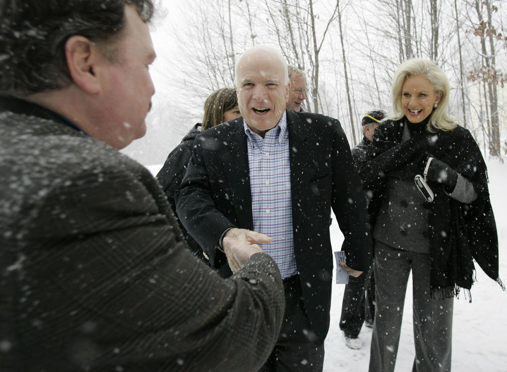 In this Jan. 1, 2008, file photo, presidential hopeful Sen. John McCain, R-Ariz., center, and his wife, Cindy, in Tilton, N.H.