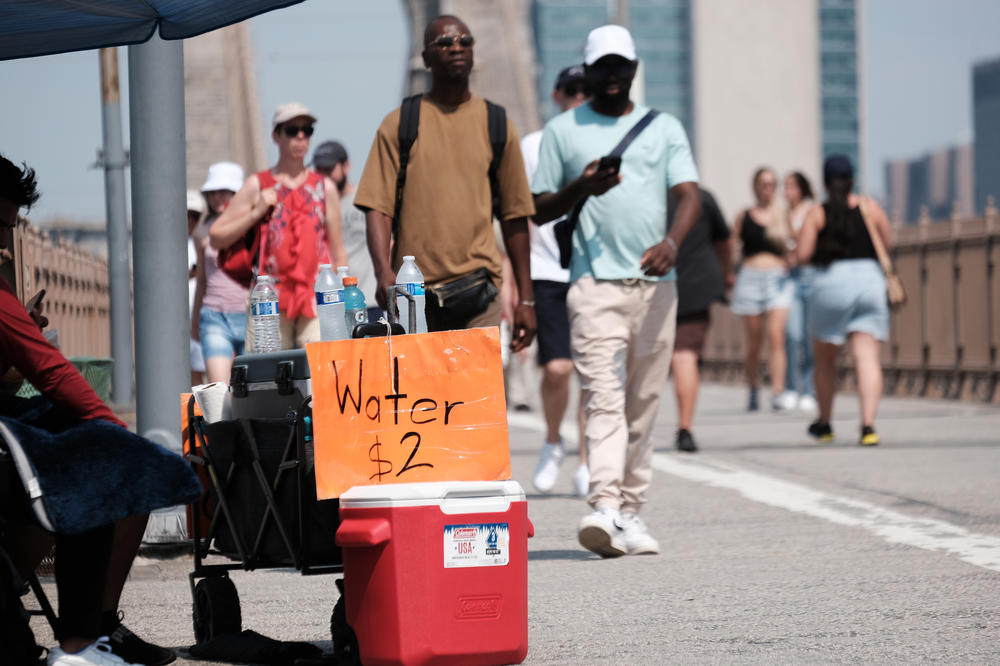 Vendors sell water along the Brooklyn Bridge on July 27.