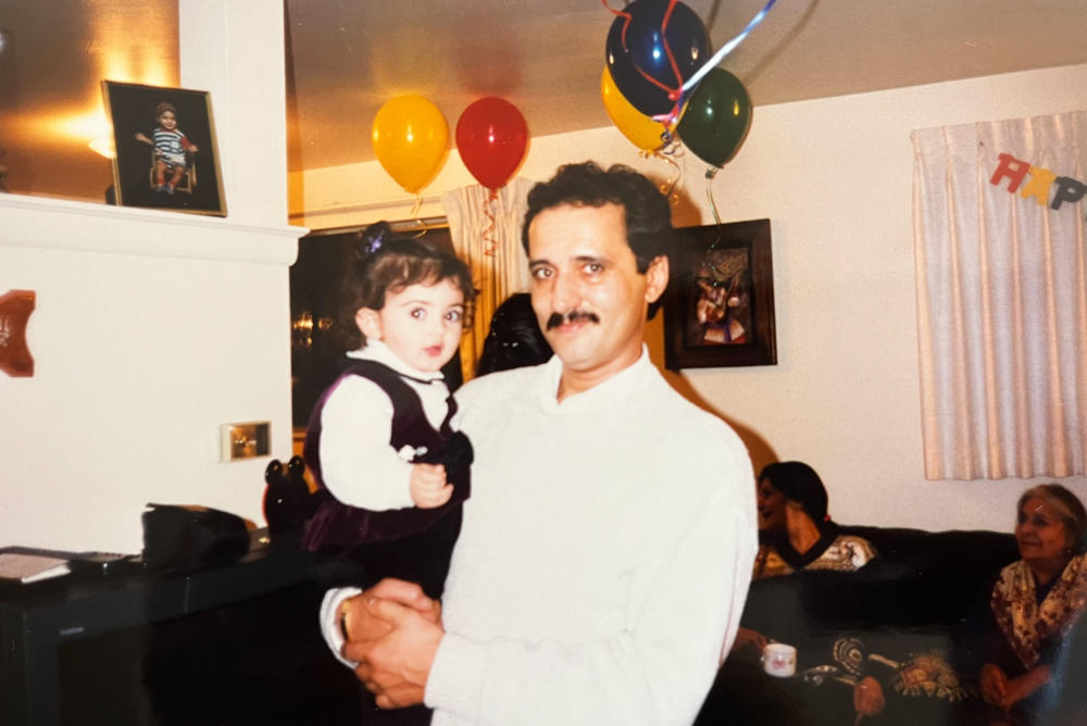 Kamyar Samimi holds his daughter, Neda Samimi-Gomez, at a birthday party in the 1990s.