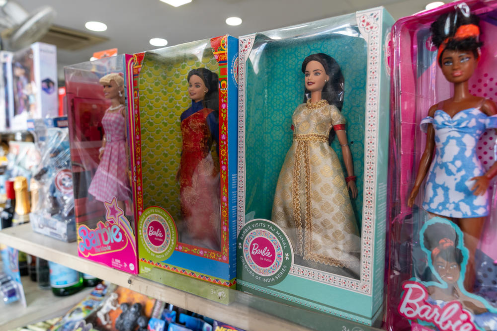 The original blond Barbie sells well in India but an Indian version with dark hair and Indian-style garments did not catch on. In this store display, Indian Barbies are flanked by a fair-haired doll and an African American Barbie.