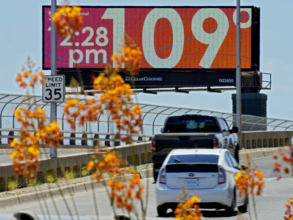 A digital billboard displays an unofficial temperature, Monday, July 17, 2023, in downtown Phoenix.