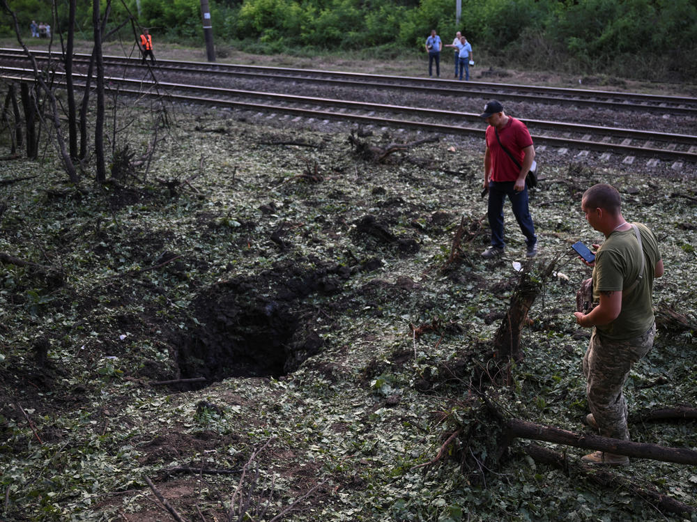 Local residents inspect a crater left after a Russian missile strike  in Zaporizhzhia, July 29.