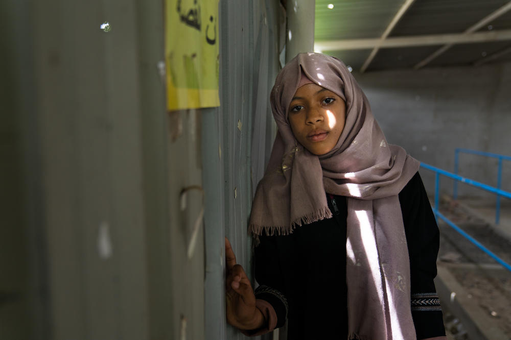 Shaimaa Ali Ahmed, 12, stands in a prosthetics center in Taiz. Her rehab is grueling, but she promised her parents she would not give up.