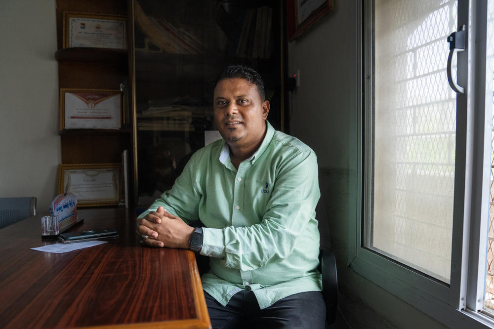 Dr. Mansour al-Wazi'iy, director of the prosthetics center, sits at his desk. This year, the center received 400 new cases of amputations. More than 100 of them were children.