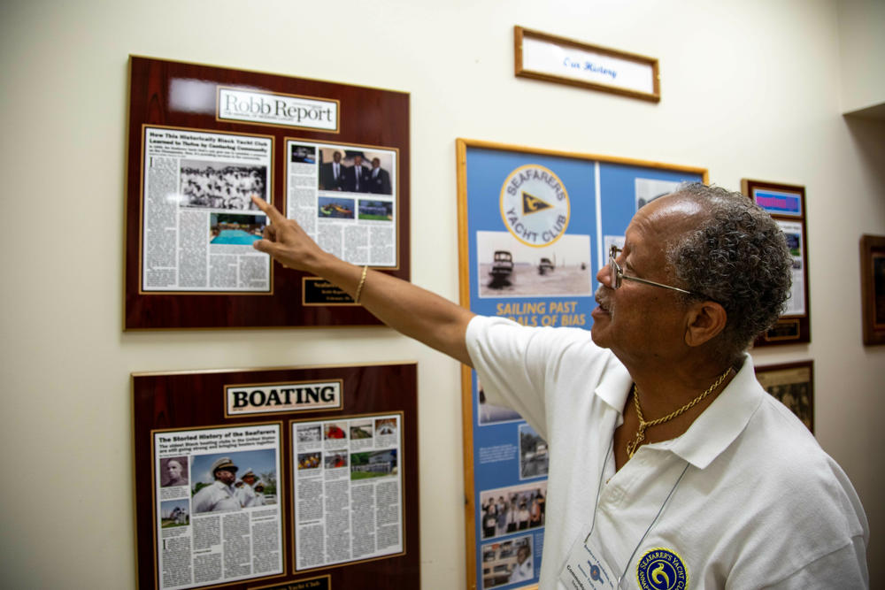 McCottry points to multiple articles written about the Seafarers Yacht Club.