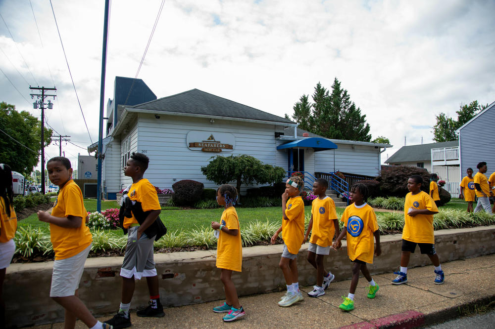 The children in the Seafarers summer youth program head to the park across the street to stretch and play games.