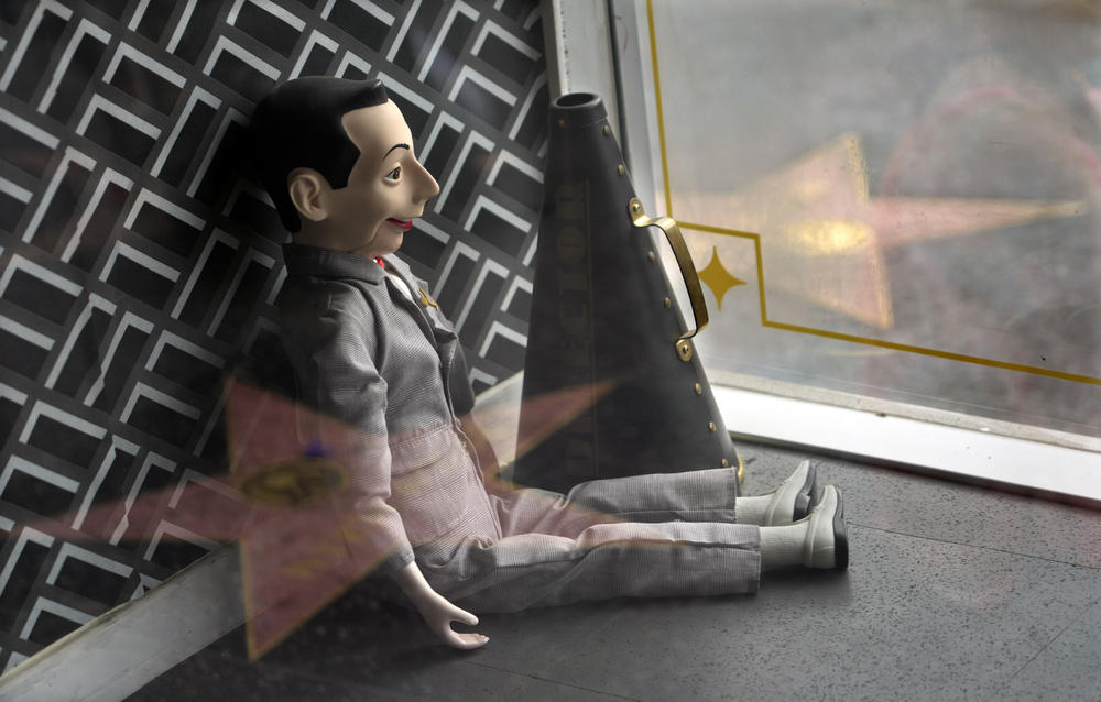 A Pee-wee Herman doll sits in a window near the character's star on the Hollywood Walk of Fame, on July 31, 2023, in Los Angeles.