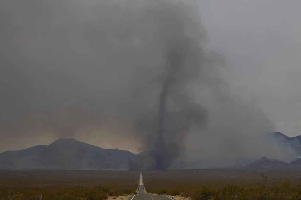 A vortex of ash rises from the York Fire on July 30 in the Mojave National Preserve, Calif.