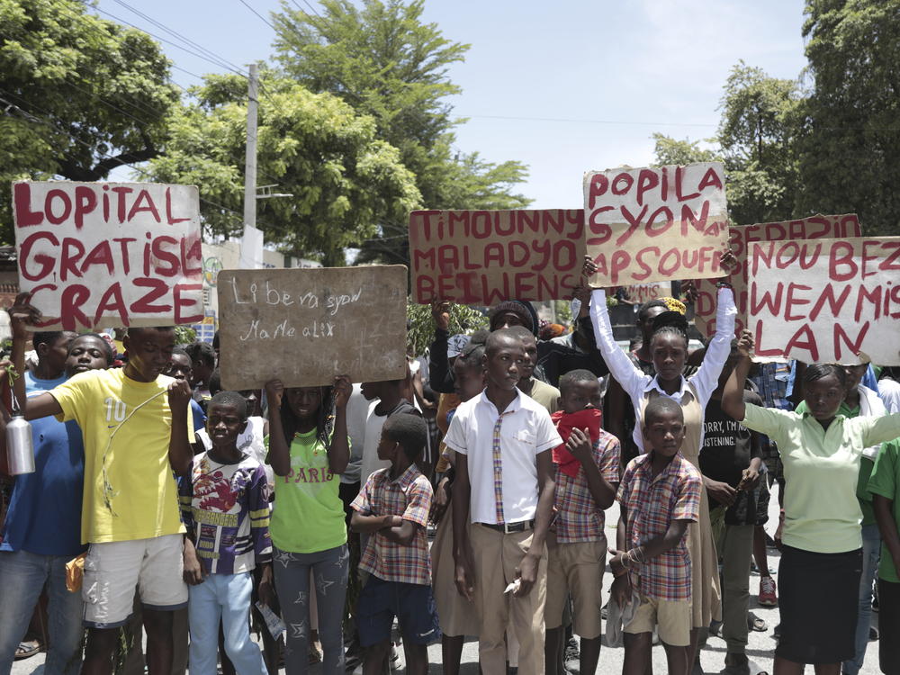 Students from the El Roi academy carry signs during a demonstration to demand the freedom of New Hampshire nurse Alix Dorsainvil and her daughter, who have been reported kidnapped, in the Cite Soleil neighborhood of Port-au-Prince, Haiti, Monday, July 31, 2023. Dorsainvil works for the El Roi Haiti nonprofit organization. (AP Photo/Odelyn Joseph)