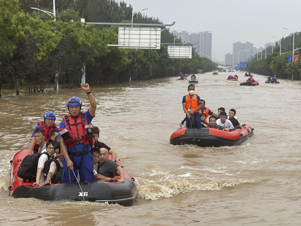 Residents are evacuated by rubber boats through flood waters in Zhuozhou in northern China's Hebei province, south of Beijing, Wednesday. China's capital has recorded its heaviest rainfall in at least 140 years over the past few days. Among the hardest hit areas is Zhuozhou, a small city that borders Beijing's southwest.