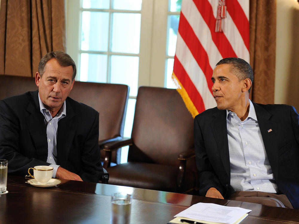 Then-President Obama speaks with Then-House Speaker John Boehner during a meeting about the debt ceiling at the White House on July 23, 2011 in Washington, D.C. S&P downgraded the U.S. rating for the first time days after both leaders clinched a deal to avoid a debt default.