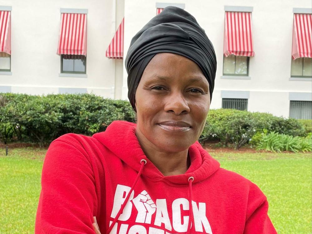 Trish Brown stands in the rain outside Florida's historic Capitol. She's there to raise awareness about social justice issues moving forward in Florida including a proposed constitutional amendment that would protect access to abortion.
