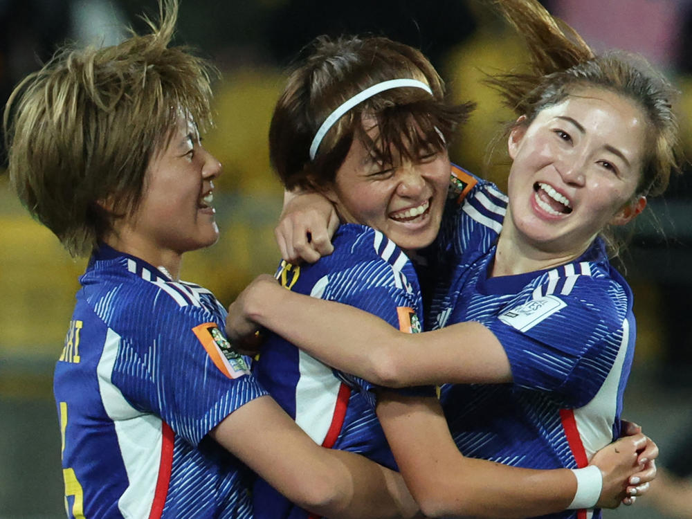 Japanese midfielder Hinata Miyazawa, center, celebrates after scoring her team's third goal during its match against Spain earlier this week. Japan is one of three teams to win all its games in the group stage.