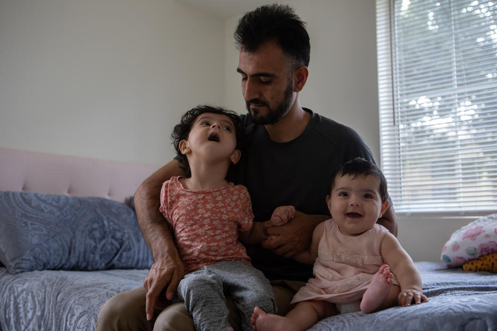Shafiullah Amani and 3-year-old Yousra and 6-month-old Iqra, on Aug. 3, 2023.