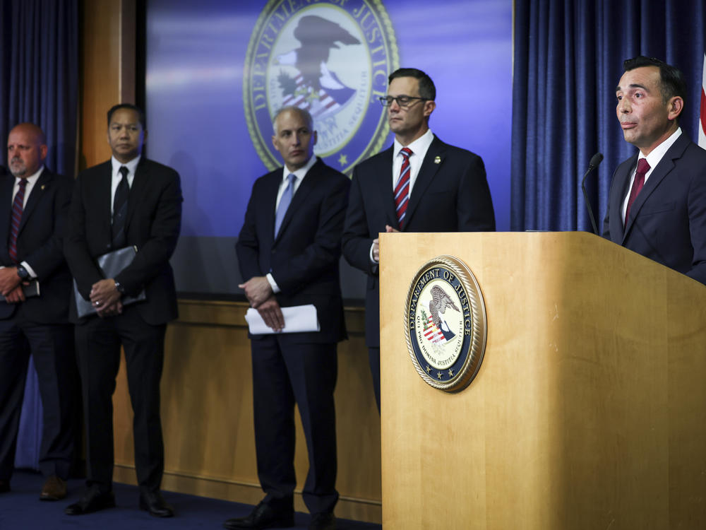 U.S. Attorney Martin Estrada for the Central District of California, right, speaks during a press conference at the U.S. Attorney's Office for the Southern District of California on Thursday, Aug. 3, 2023, in San Diego.