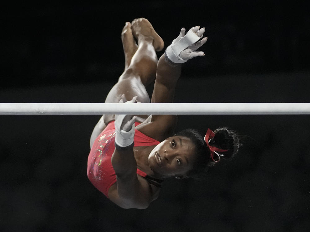 Biles practices on the uneven bars on Friday.