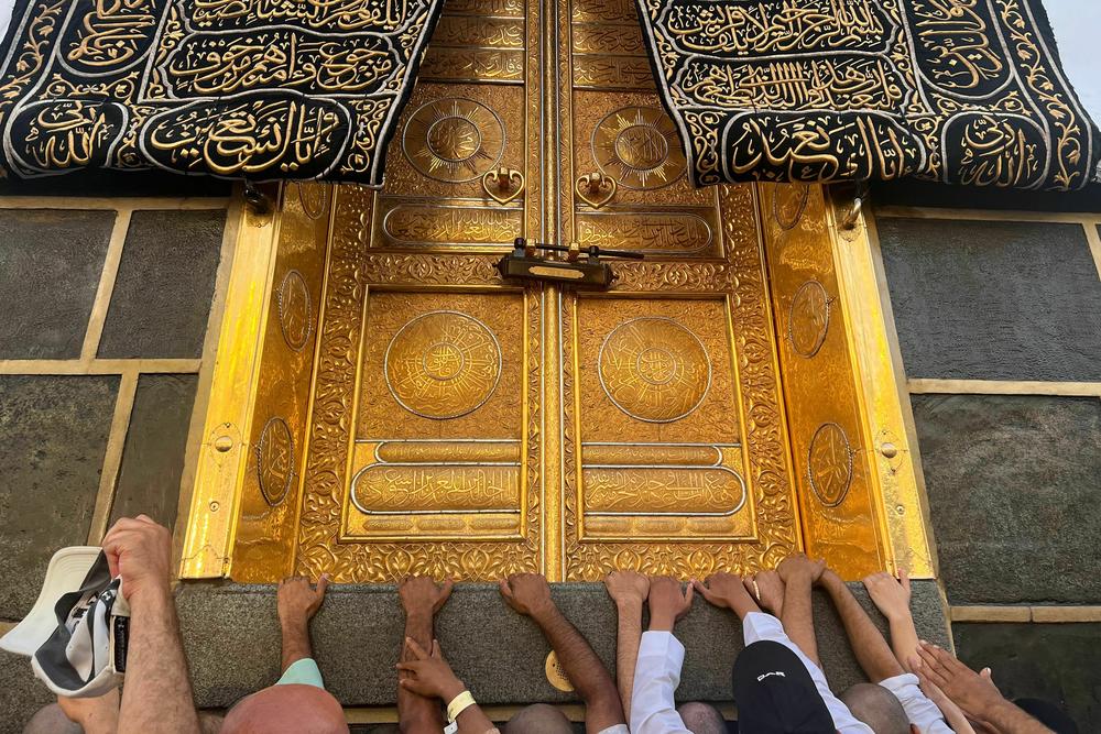 Muslim pilgrims try to touch the main door of Kaaba, Islam's holiest shrine, at the Grand Mosque in the holy city of Mecca during the annual Hajj pilgrimage, on June 30.
