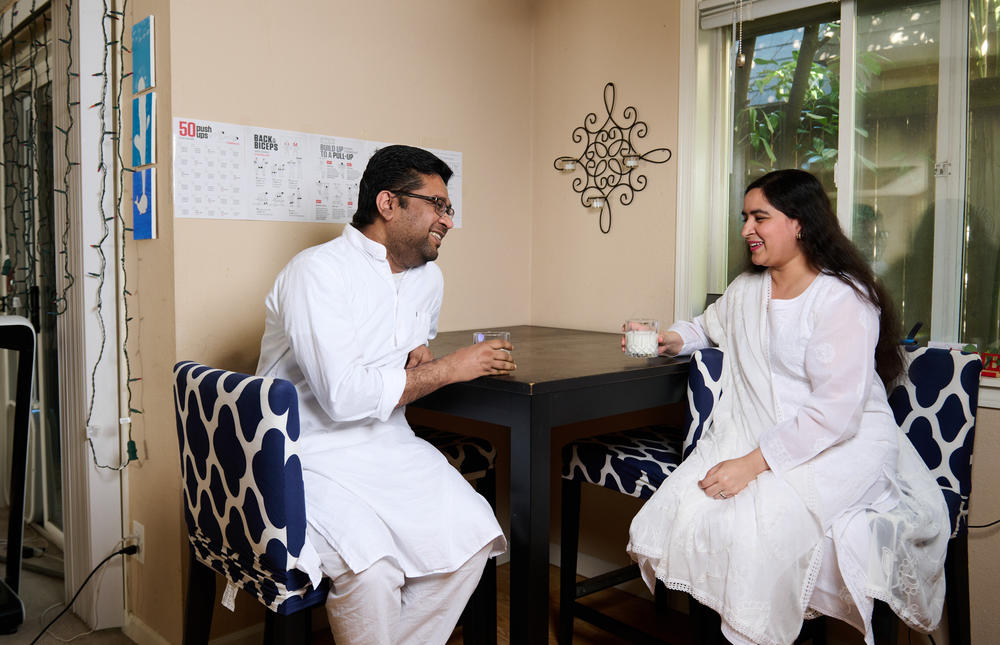 Heat researcher Gulrez Azhar and his spouse, Afreen Fatima, enjoy lassi at home in Bellevue, Washington. The family tends to drink lassi in the late afternoon during the hottest part of the day. Azhar cites its ingredients as helpful in staying hydrated and healthy during extreme heat.
